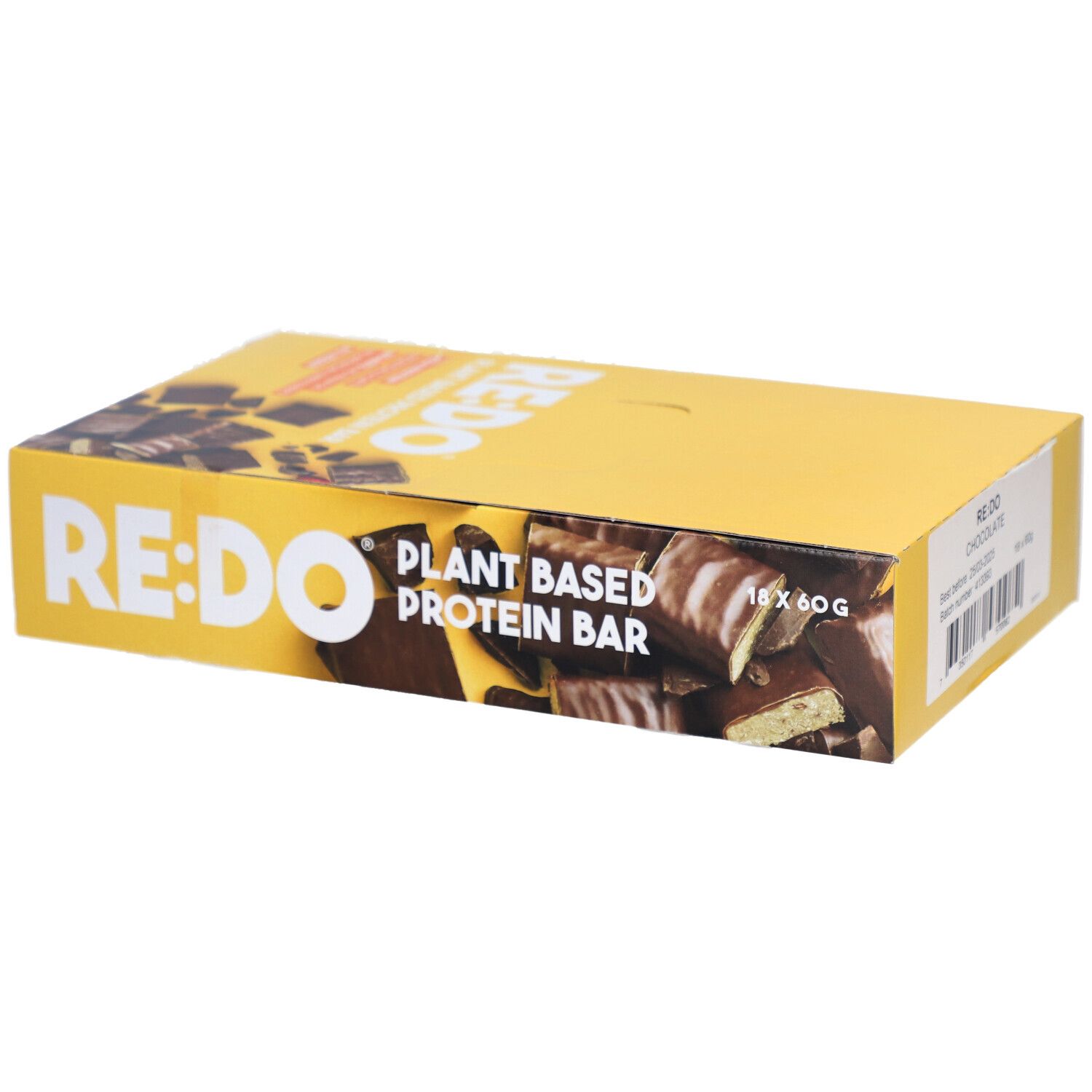 Gelbe Schachtel mit RE:DO-Schokoriegeln. Aufschrift: Plant Based Protein Bar. Enthält 18 Riegel à 60g. Aufkleber: RE:DO Chocolate.