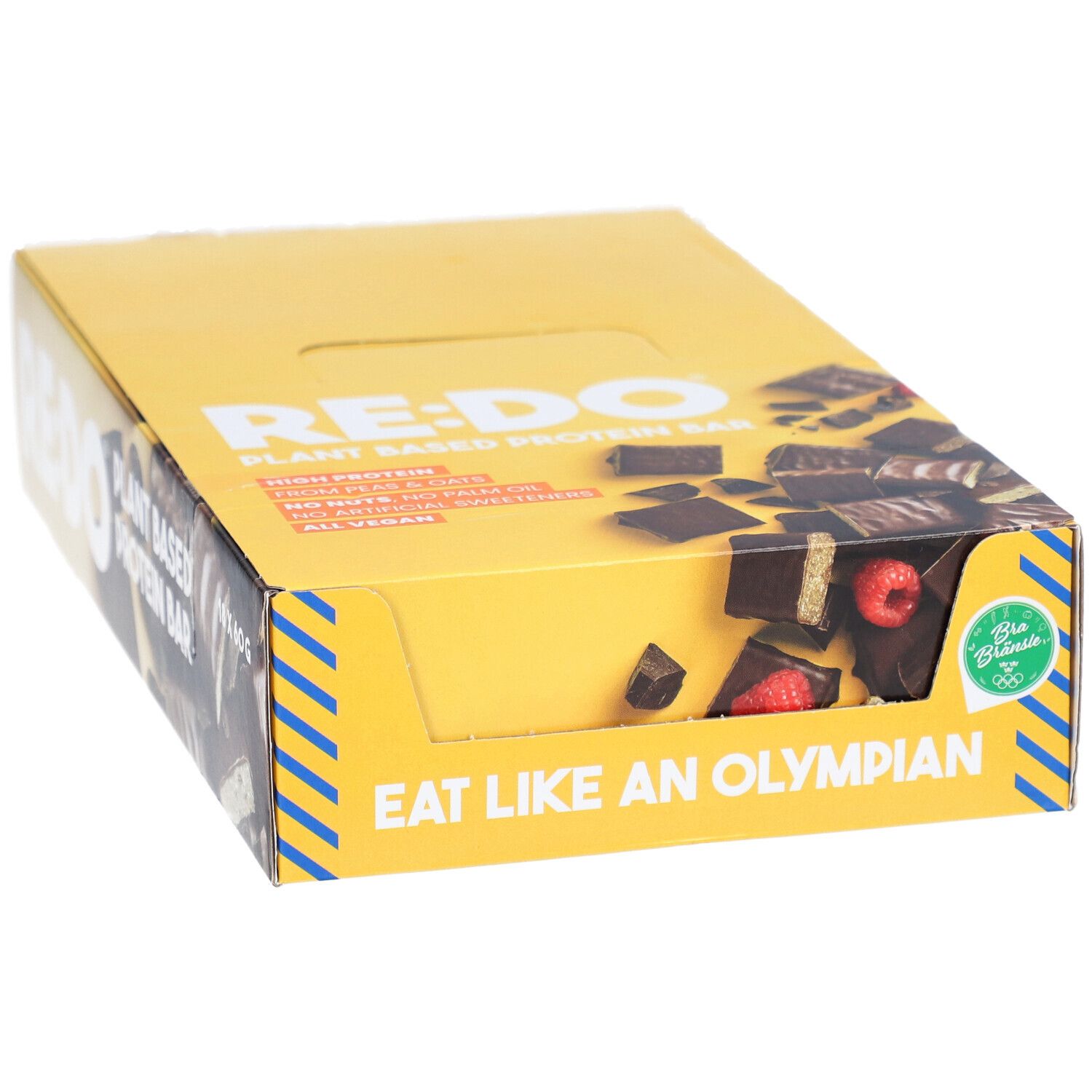 Gelbe Schachtel mit RE:DO-Schokoriegeln. Aufschrift: Plant Based Protein Bar. Sichtbar: Riegelstücke mit Himbeeren. Aufschrift: Eat like an Olympian. Vegan.