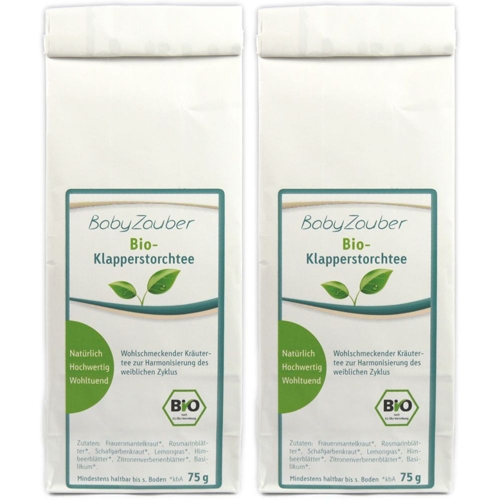 Zwei Beutel BabyZauber Bio-Klapperstorchtee. Weißer Beutel mit grünem Etikett, Produktname und Bio-Siegel. 75g.