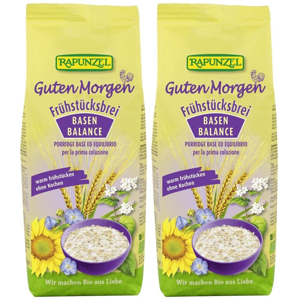 Zwei Beutel RAPUNZEL Frühstücksbrei. Aufschrift: Guten Morgen Frühstücksbrei, Basen Balance. Abbildung von Getreide, Blumen und einer Schüssel Brei.