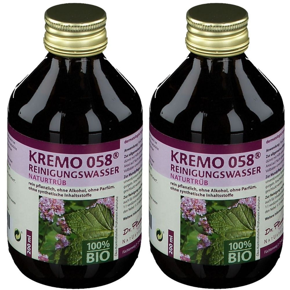 Zwei Flaschen mit dunkler Flüssigkeit. Etikett mit Aufschrift "KREMO 058 REINIGUNGSWASSER NATURTRÜB". 100% BIO-Siegel.
