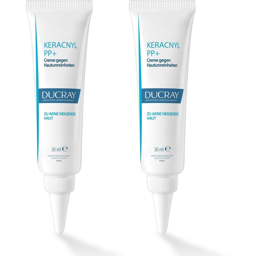 Zwei weiße Tuben mit blauer Schrift. Aufschrift: KERACNYL PP+ Creme gegen Hautunreinheiten, DUCRAY, 30 ml.