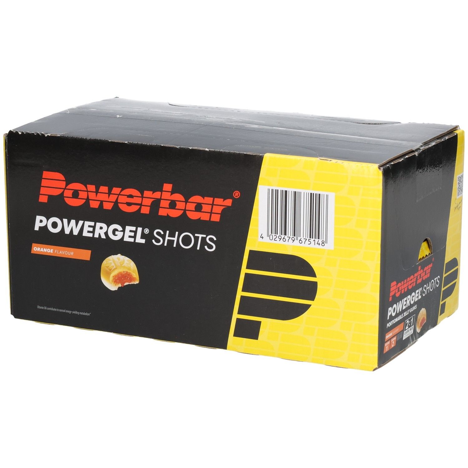 Schwarzer Karton mit Powerbar Powergel Shots. Orangefarbene Geleestücke sind abgebildet. Text: Orange Flavor.