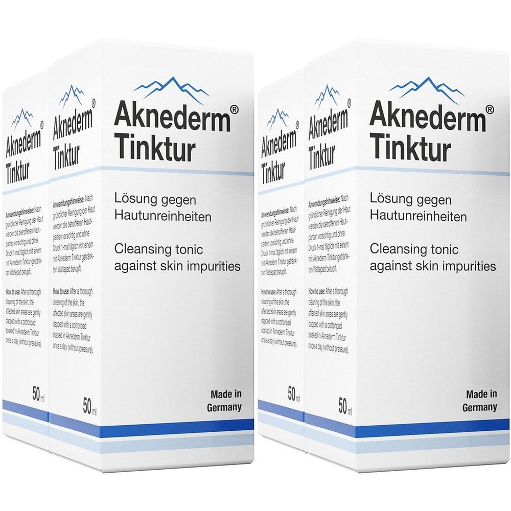Zwei weiße Kartons mit Produktnamen Aknederm Tinktur. Text: Lösung gegen Hautunreinheiten, Cleansing tonic against skin impurities. Made in Germany.