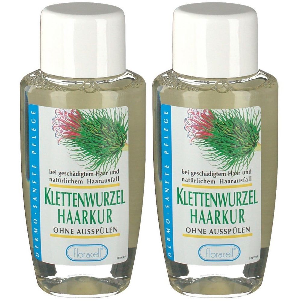 Zwei Flaschen Klettenwurzel Haarkur. Klare Flüssigkeit in durchsichtigen Flaschen mit weißen Deckeln. Etikett mit Text und Logo.