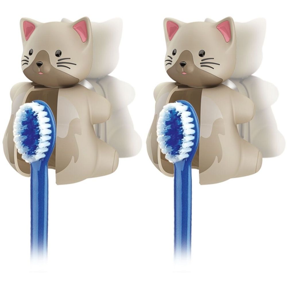 Zwei Zahnbürstenhalter in Katzenform. Beige mit rosa Ohren. Blaue Zahnbürsten sind eingesetzt.