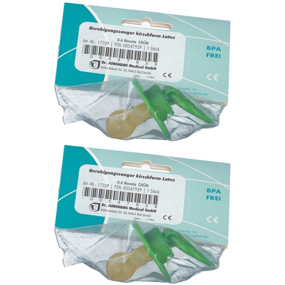 Zwei Schnuller in Verpackung. Sauger gelb, Schild grün. Aufschrift: Beruhigungssauger, 0-6 Monate, BPA frei, CE-Zeichen.