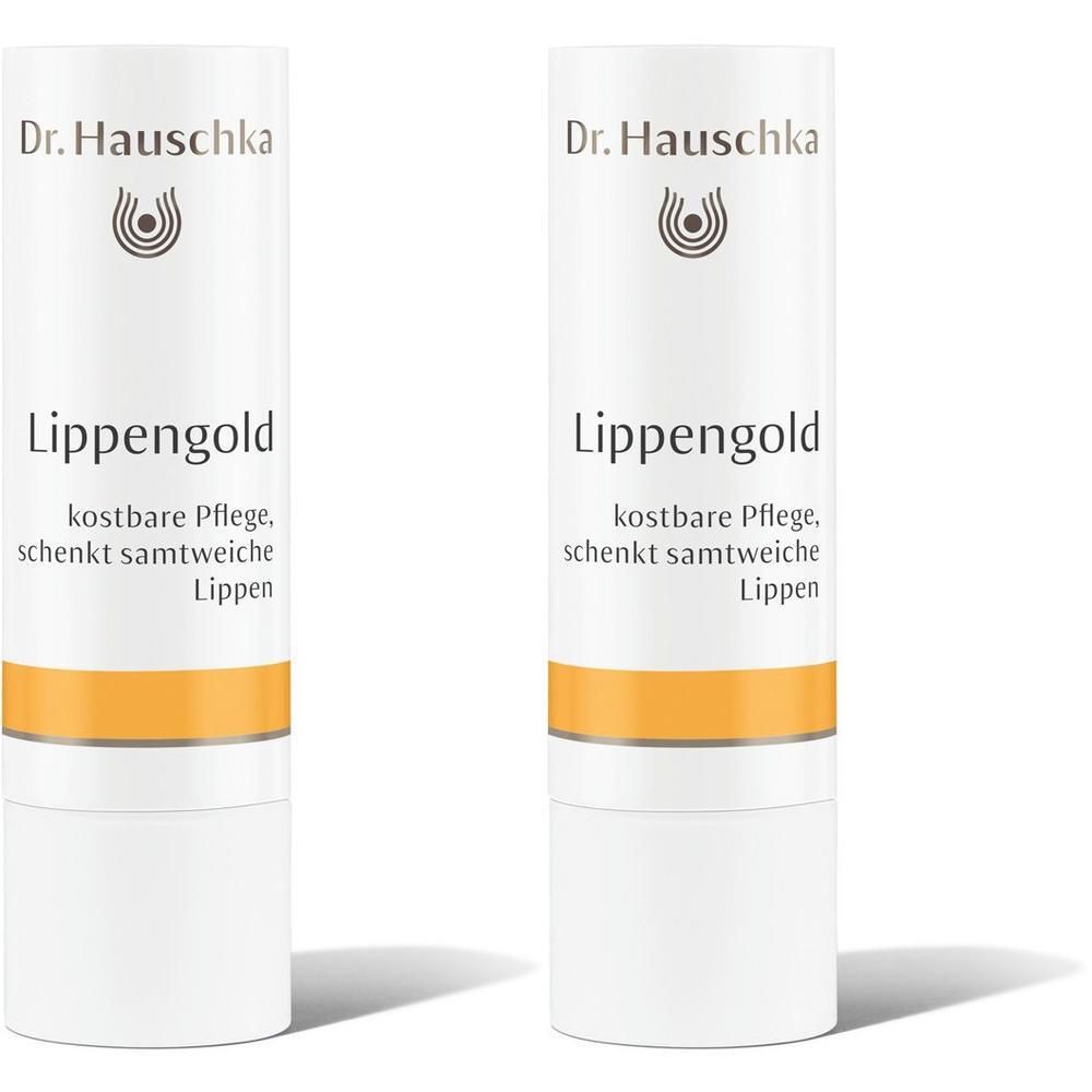 Zwei Dr. Hauschka Lippengold Stifte mit goldfarbenem Band und weißem Gehäuse.