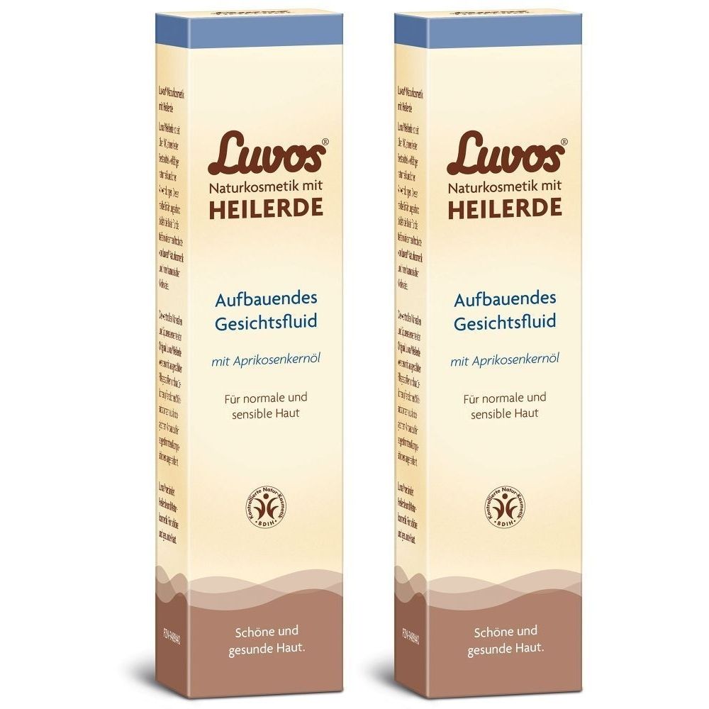 Zwei rechteckige Faltschachteln. Aufschrift: Luvos Heilerde Aufbauendes Gesichtsfluid. Für normale und sensible Haut.