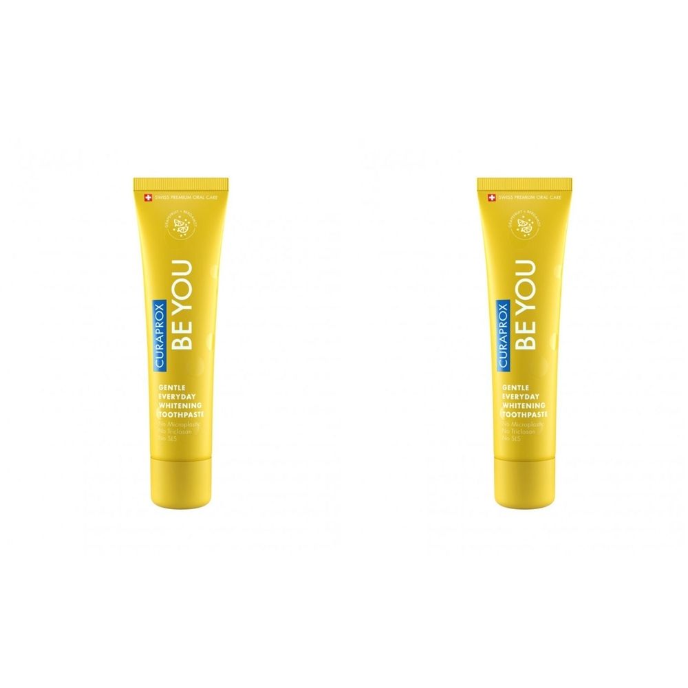 Zwei gelbe Zahnpasta-Tuben. Auf jeder Tube steht "BE YOU" und "CURAPROX". Die Tuben haben einen gelben Deckel und blaue Schrift.