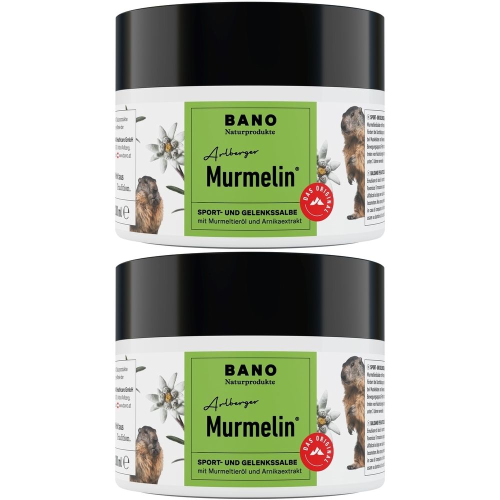 Zwei Tiegel mit schwarzem Deckel. Auf dem Etikett: Murmeltiersalbe, Logo, Text. Grün-weißes Design. Aufschrift: SPORT- UND GELENKSSALBE.