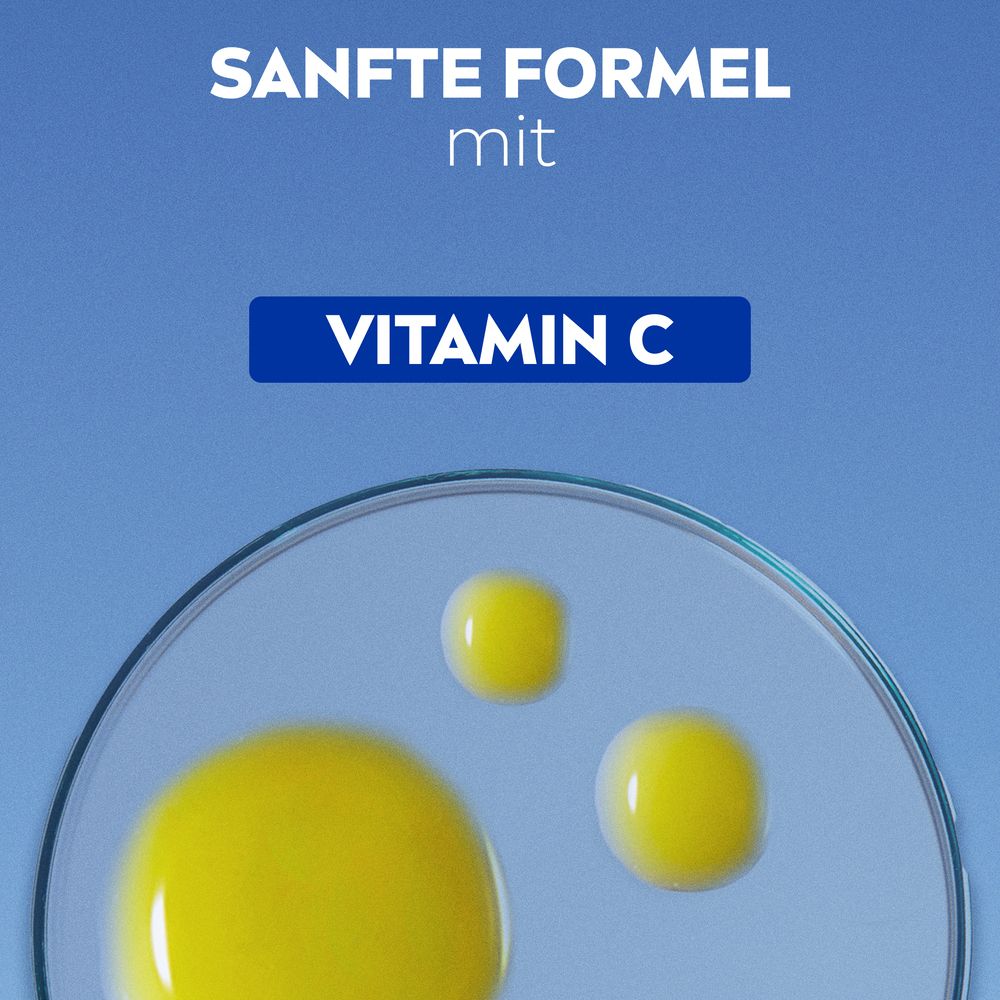 Gelbe Flüssigkeitstropfen. Vitamin C. Auf blauem Hintergrund.