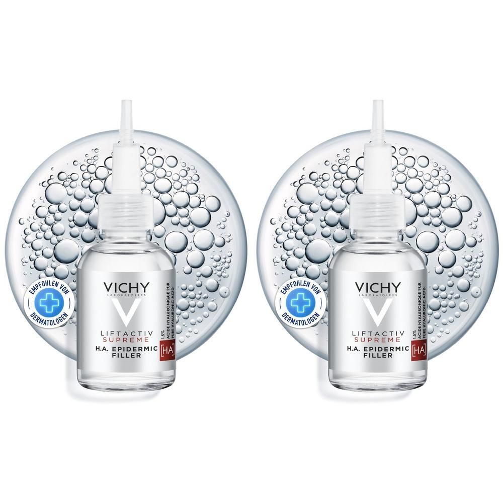 Zwei Flakons VICHY LIFTACTIV H.A. Epidermic Filler. Klare Flüssigkeit in Glasflaschen mit Applikator. Auf blauem Hintergrund.