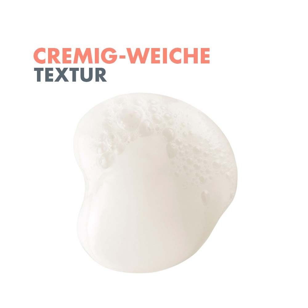 Nahaufnahme einer cremigen, weißen Textur. Text: Cremig-weiche Textur.