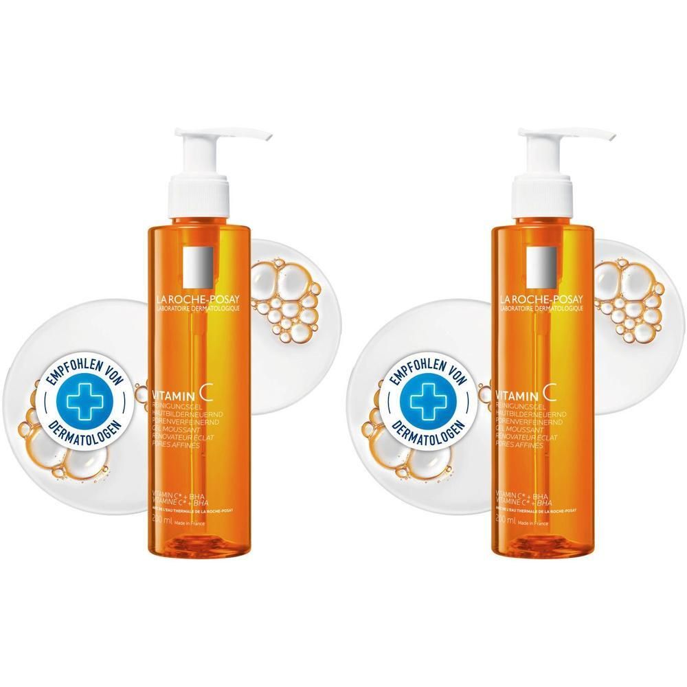 Zwei Flaschen Reinigungsgel mit Dosierpumpe. Orangefarbene Flüssigkeit. Aufkleber mit Produktinformationen. Empfohlen von Dermatologen.