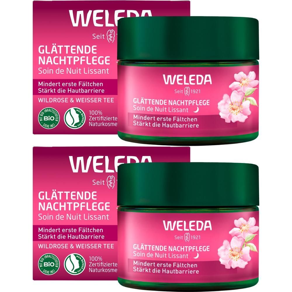 Zwei Packungen und zwei Tiegel WELEDA Nachtpflege. Rosa Tiegel mit grünem Deckel. Aufschrift: Wildrose & weißer Tee. Bio-Zertifizierung.