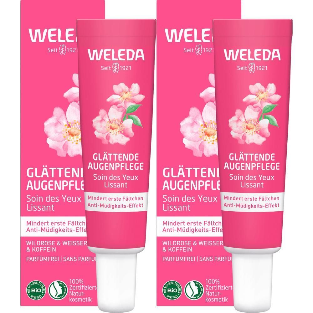 Zwei Tuben WELEDA glättende Augenpflege. Rosa Tuben mit Blütenmotiv und Text.  'Glättende Augenpflege' und 'Wildrose & weißer Tee'.