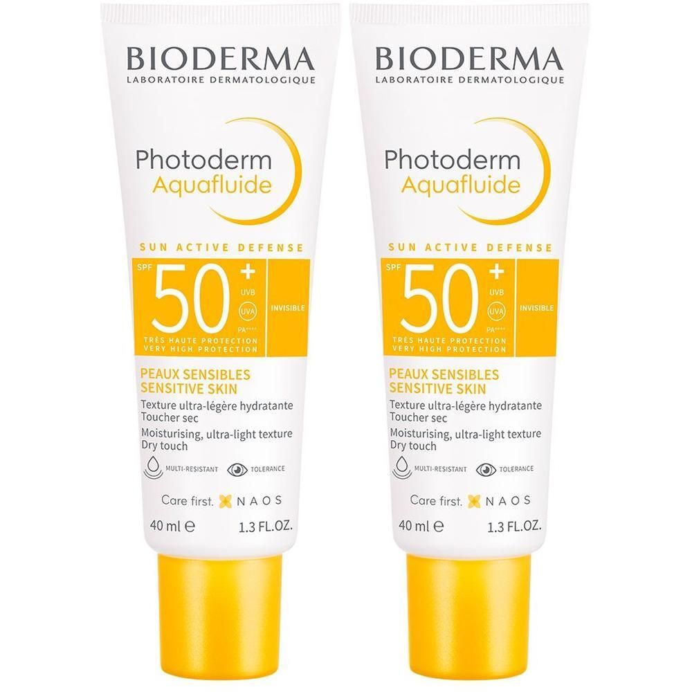 Zwei Tuben BIODERMA Photoderm Aquafluide 50+. Weiße Tuben mit gelbem Verschluss. Aufdruck: SPF 50+, Text und Logo.