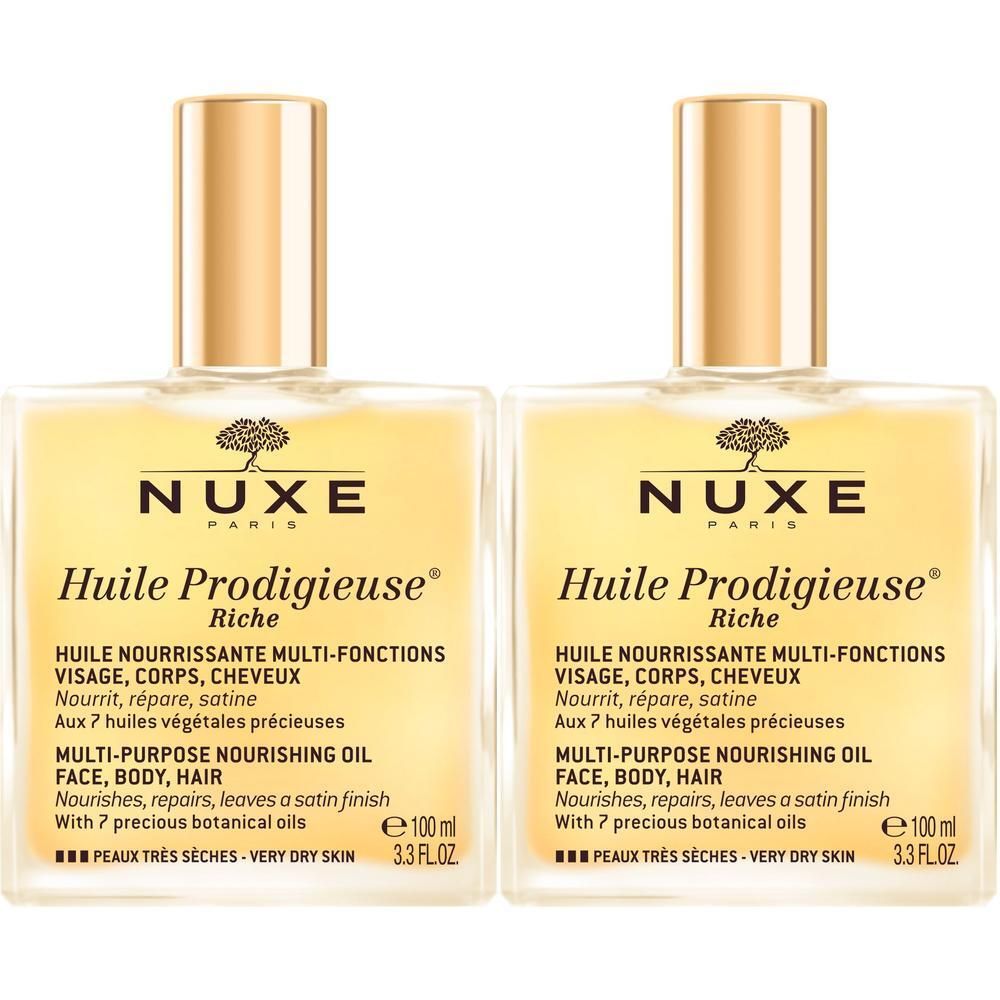 Zwei Flaschen NUXE Huile Prodigieuse riche. Quadratische Flaschen mit goldfarbenen Verschlüssen. Text auf Etikett.