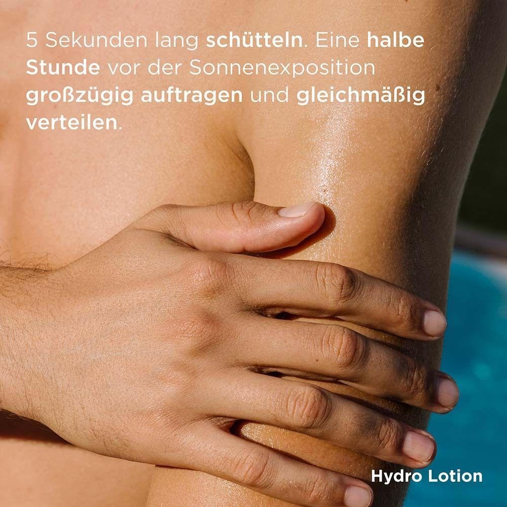 Eine Flasche mit gelbem Deckel und blau-grünem Boden. Aufschrift: ISDIN Hydro Lotion 50. Text: Chlorella Maris, Detox.