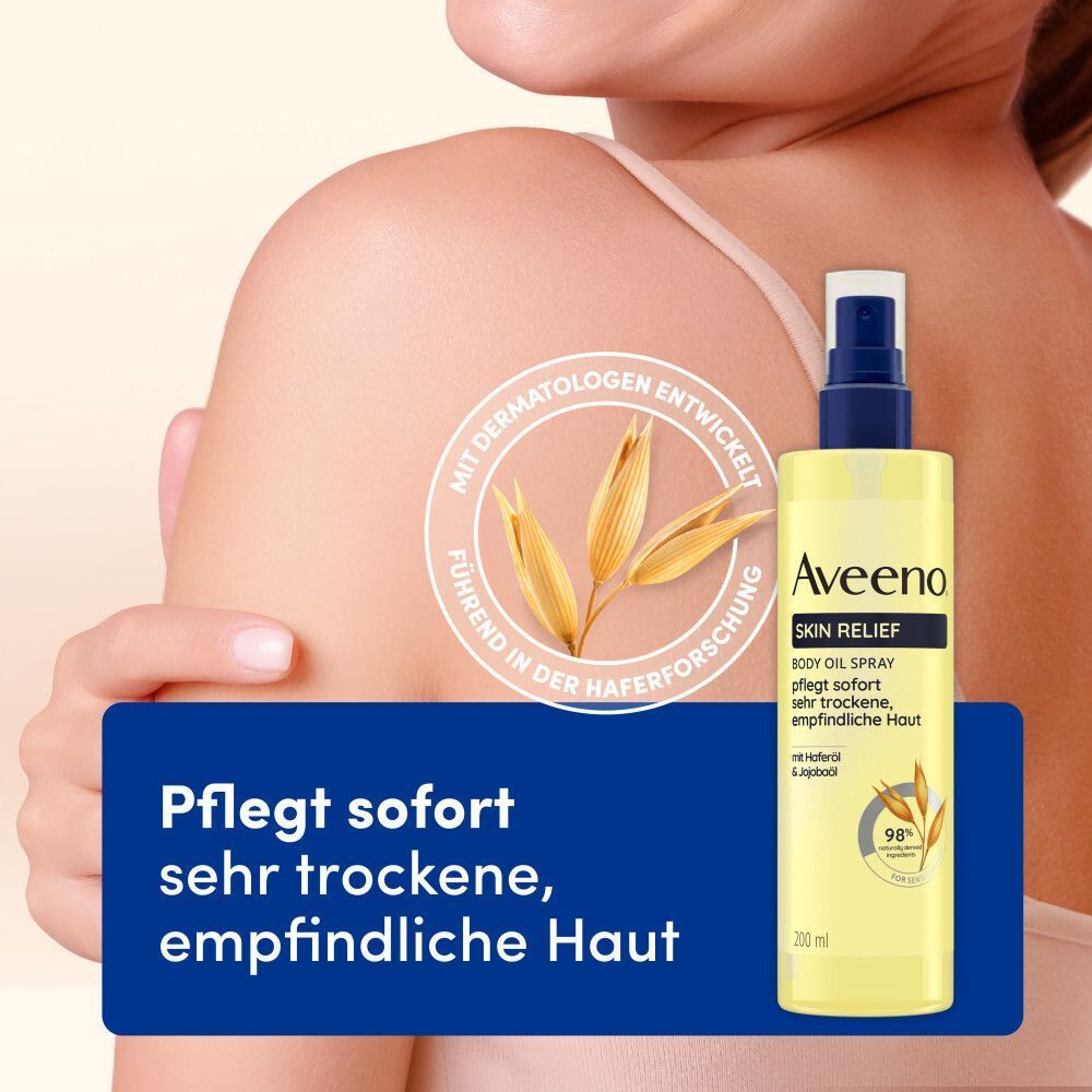 Gelbe Sprühflasche mit blauem Verschluss. Aufschrift: Aveeno Skin Relief Body Oil Spray. Mit Haferforschung. Auf Haut abgebildet.