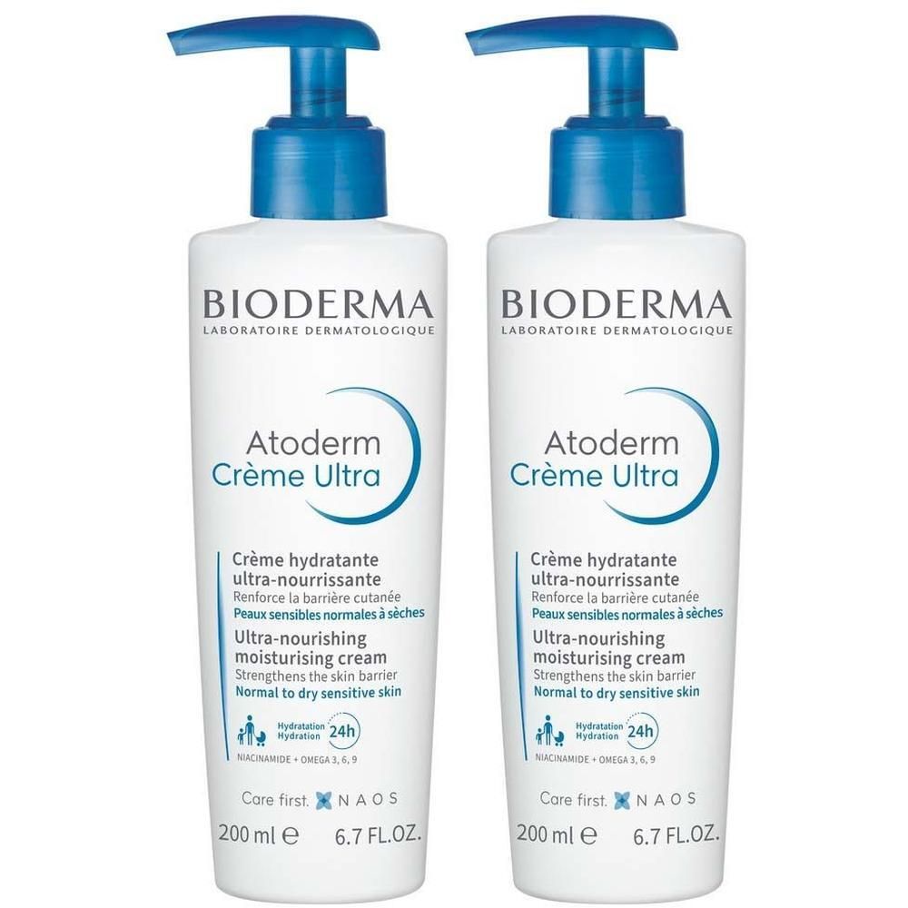 Zwei weiße Flaschen mit blauem Pumpverschluss. Aufschrift: BIODERMA, Atoderm Crème Ultra. Text in mehreren Sprachen.