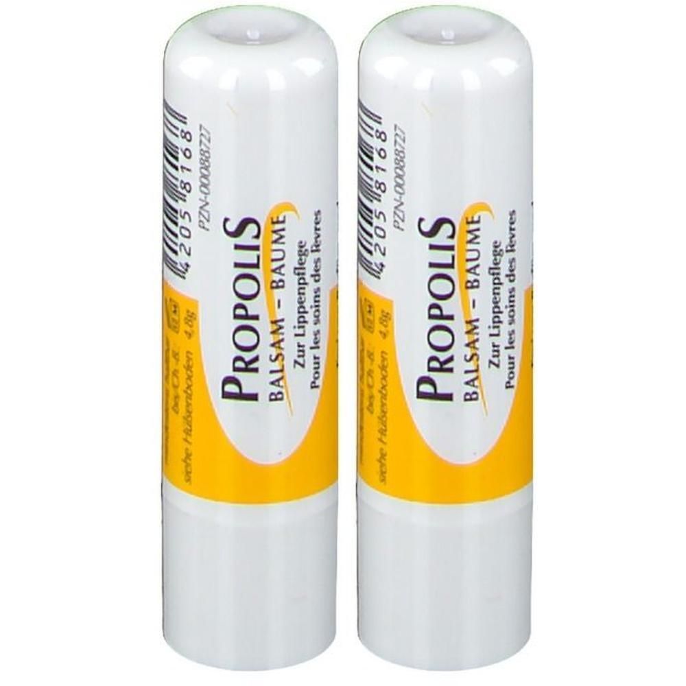 Zwei weiße Lippenpflegestifte mit gelben Akzenten. Aufschrift: PROPOLIS BALSAM-BAUME. Barcode und Text.