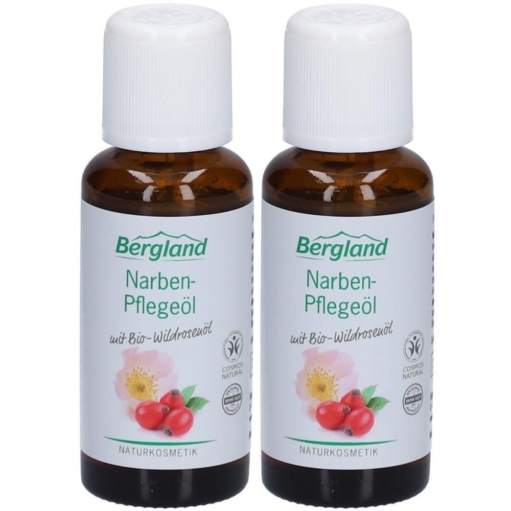 Zwei braune Flaschen mit weißem Deckel. Auf dem Etikett steht "Bergland Narben-Pflegeöl". Abbildung einer Hagebutte und Blüte. Naturkosmetik.