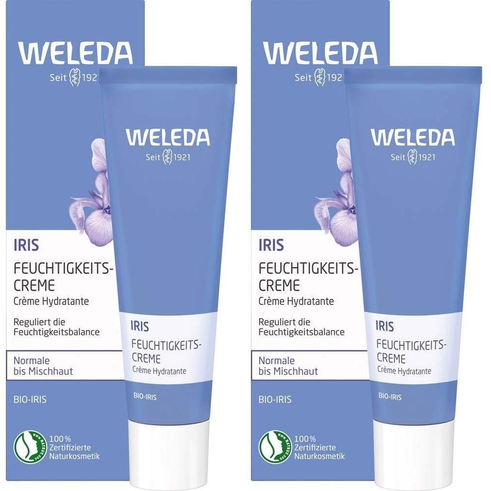 Zwei Tuben Weleda Iris Feuchtigkeitscreme mit Verpackung. Blaue Tube mit Iris-Blüten-Illustration. Zertifiziertes Naturkosmetik-Siegel.