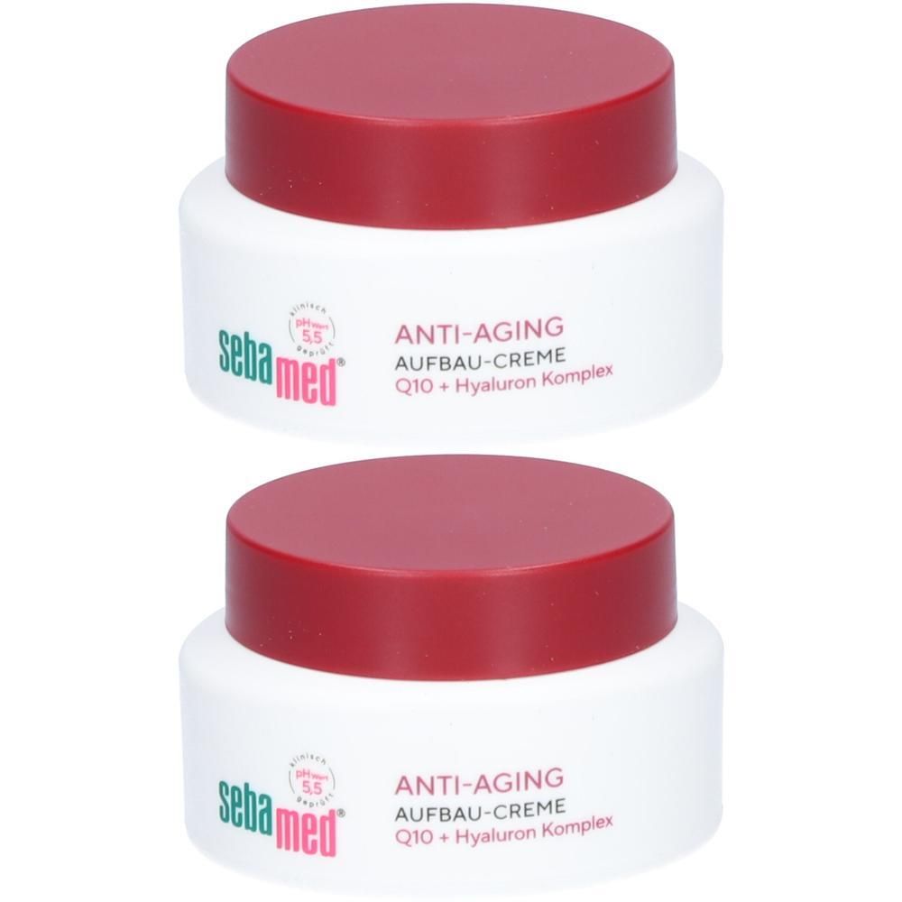 Zwei Tiegel Anti-Aging Aufbau-Creme mit rotem Deckel. Aufschrift: sebamed, Anti-Aging Aufbau-Creme, Q10 + Hyaluron Komplex.