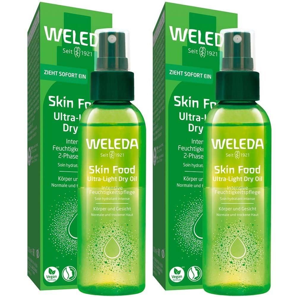 Zwei Flaschen WELEDA Skin Food Ultra-Light Dry Oil mit grünen Sprühköpfen und Verpackungen. Vegan-Siegel.