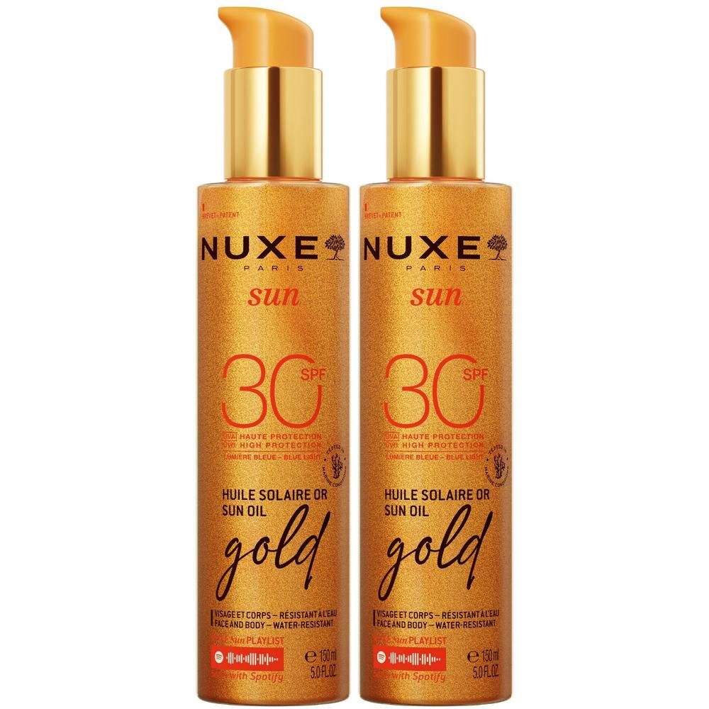 Zwei goldfarbene Flaschen mit Pumpverschluss. Aufschrift: NUXE Sun, SPF 30, Huile Solaire Or, gold.