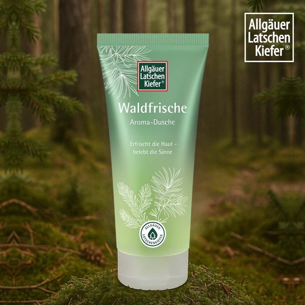 Grüne Tube. Aufschrift: Waldfrische Aroma-Dusche. Hintergrund: Wald. Logo oben rechts. Siegel unten.