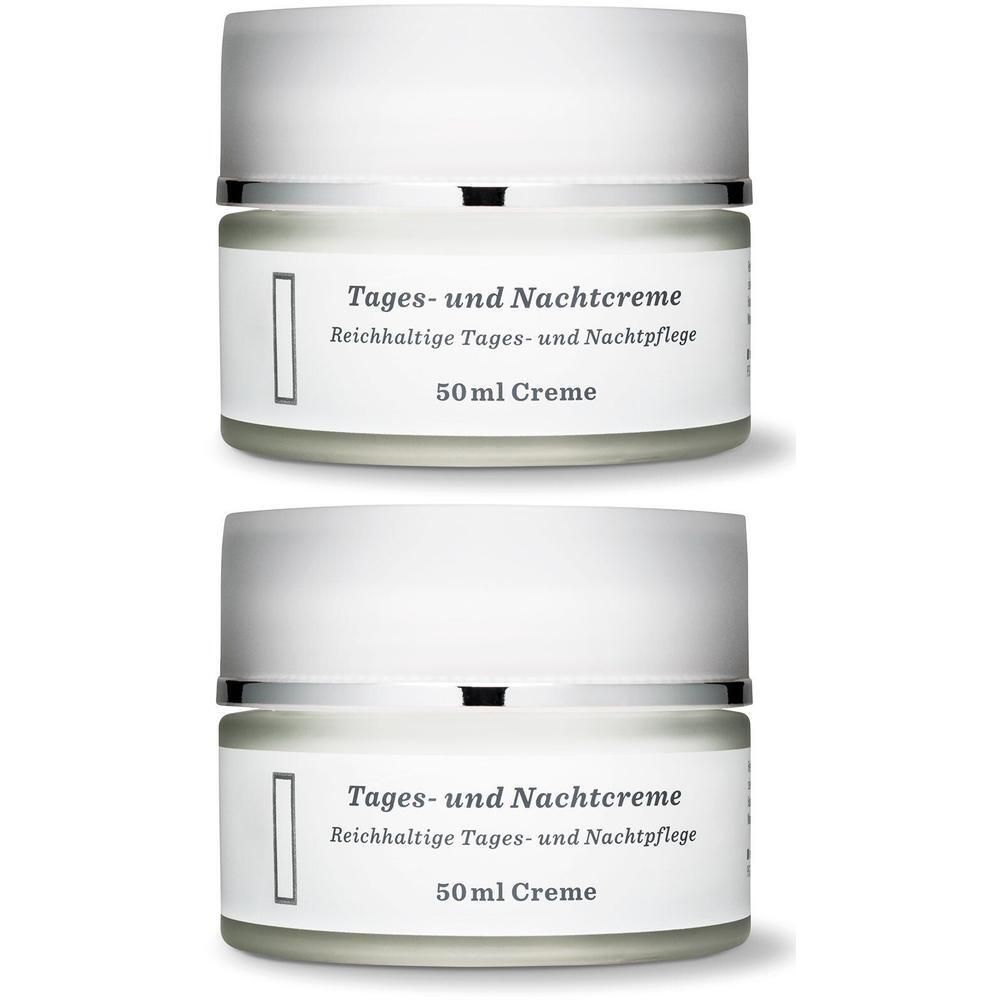 Zwei Cremetiegel mit Deckel. Etikett mit Text: Tages- und Nachtcreme, reichhaltige Tages- und Nachtpflege, 50ml Creme.