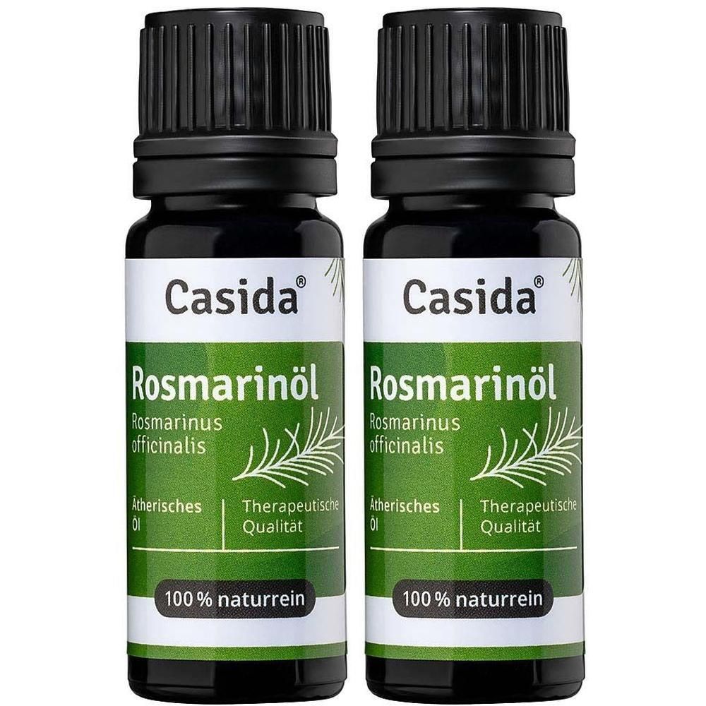 Zwei Flaschen mit schwarzem Deckel und Etikett. Aufschrift: Casida, Rosmarinöl, 100% naturrein.