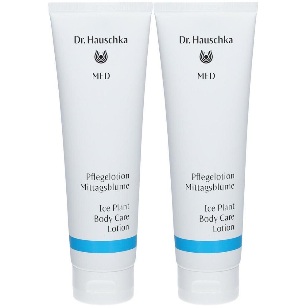Zwei weiße Tuben mit blauer Banderole. Aufschrift: Dr. Hauschka MED Pflegelotion Mittagsblume.