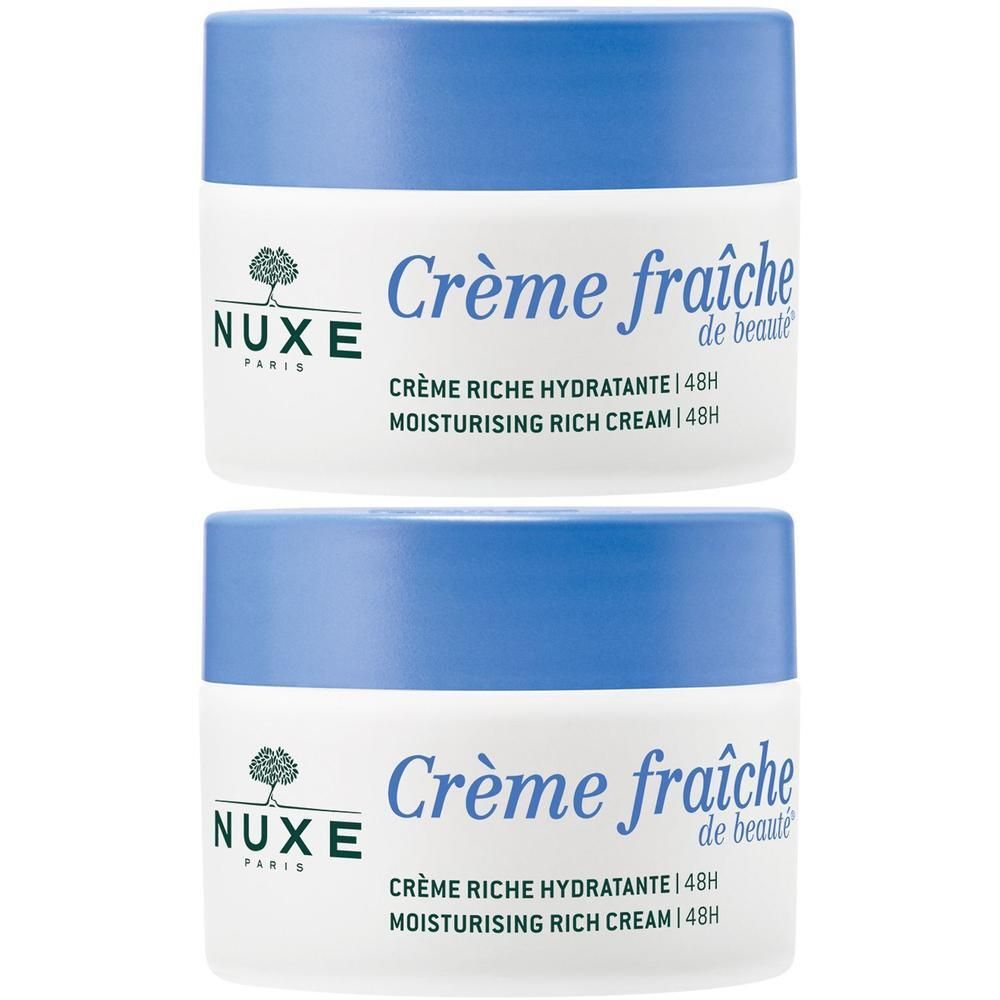 Zwei Tiegel NUXE Crème Fraîche, weißes Gefäß mit blauem Deckel. Aufschrift: Crème fraîche de beauté, 48H Feuchtigkeit.