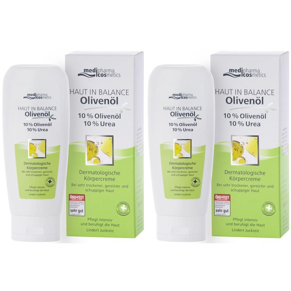 Zwei Tuben und zwei Kartons medipharma cosmetics Olivenöl Haut in Balance Körpercreme. Weiße Tuben, grüne Verpackung, Text.
