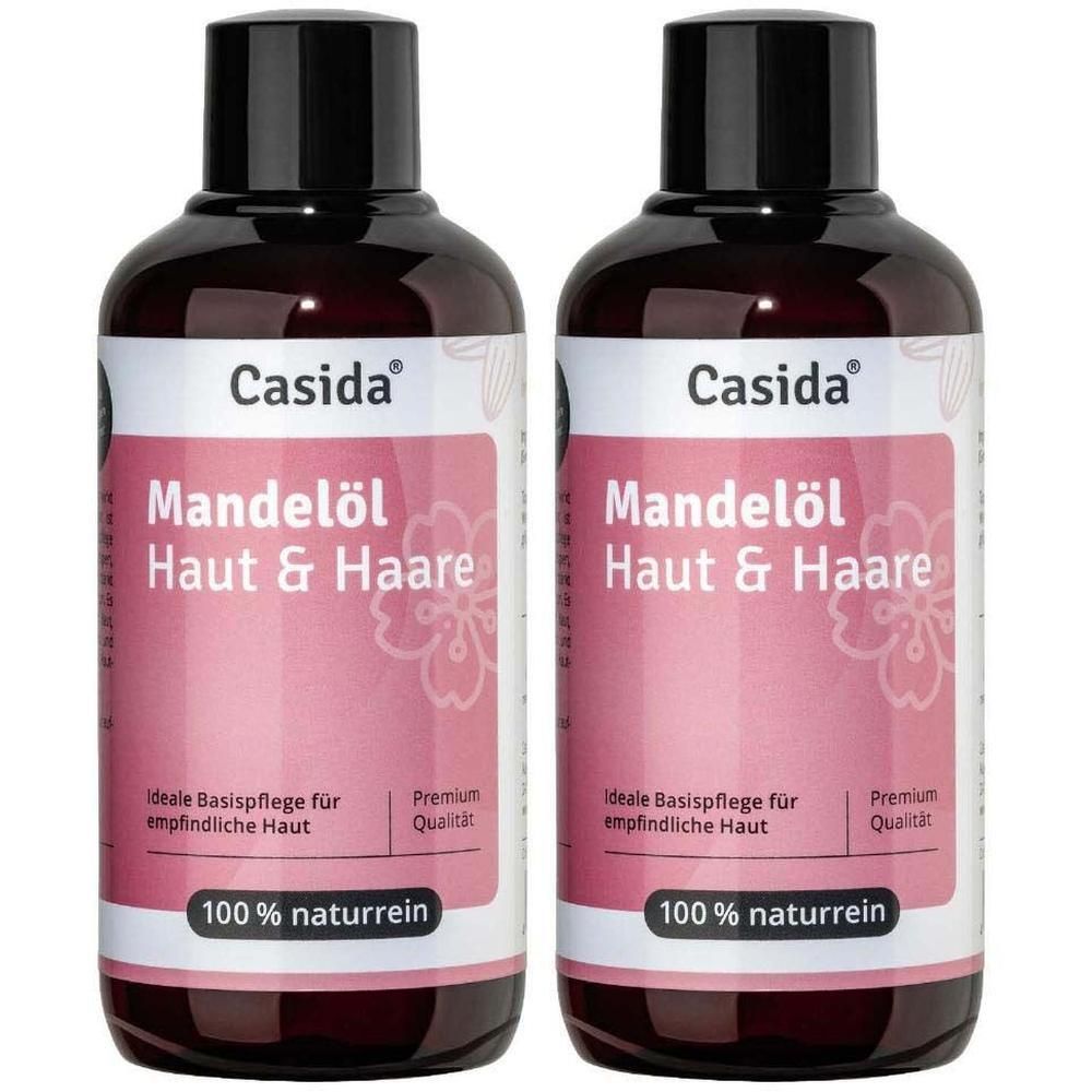 Zwei Flaschen MANDELÖL Haut & Haare naturrein. Braune Flaschen mit schwarzen Deckeln und weißen Etiketten. Aufschrift: Casida, Mandelöl Haut & Haare.