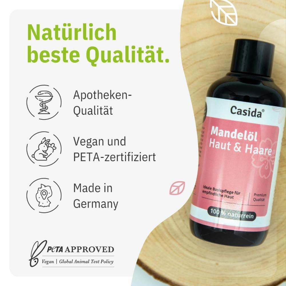 Eine Flasche MANDELÖL Haut & Haare naturrein. Braune Flasche mit schwarzem Deckel und weißem Etikett. Aufschrift: Casida, Mandelöl Haut & Haare. Vegan und PETA-zertifiziert.