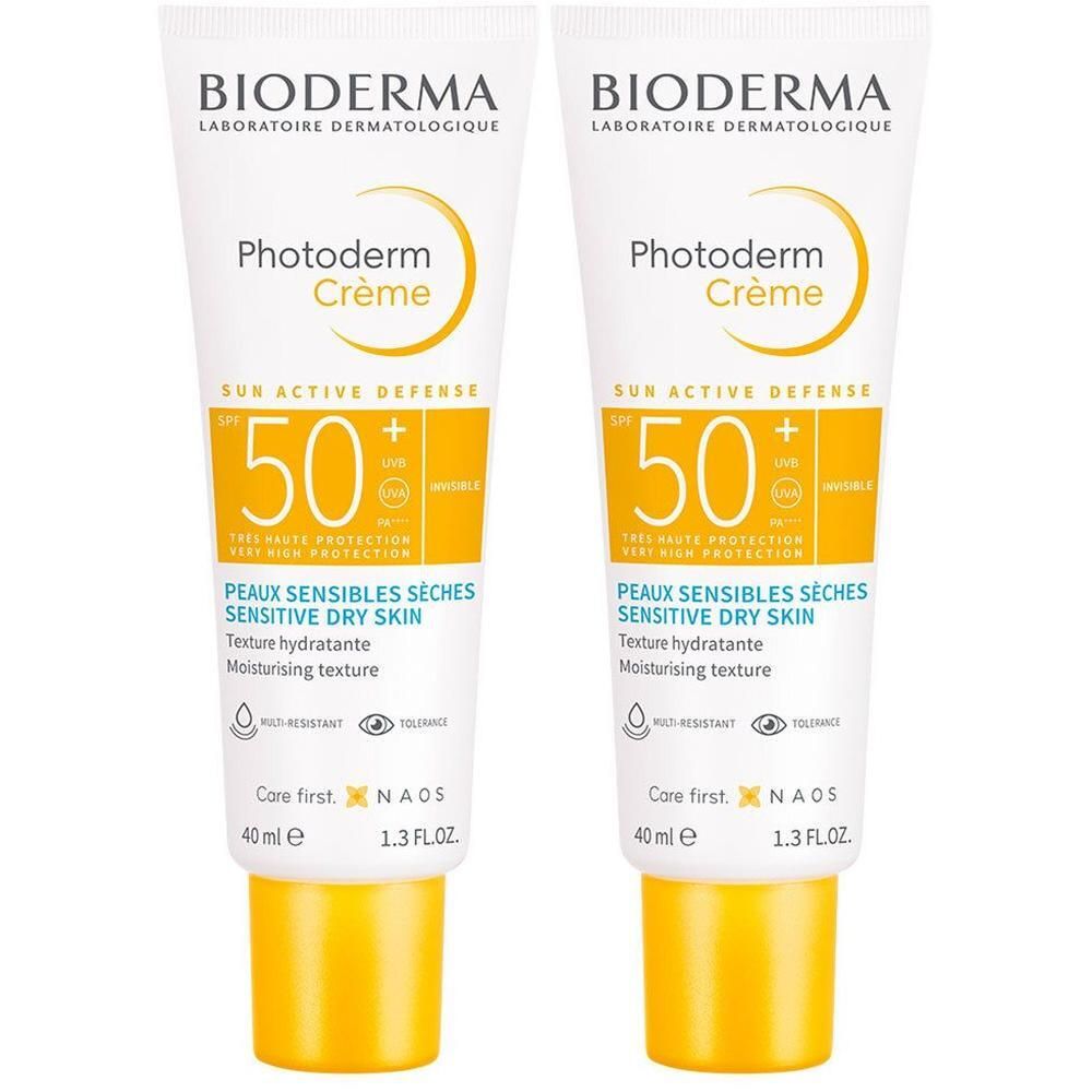 Zwei Tuben BIODERMA Photoderm Creme SPF 50+. Weiße Tuben mit gelben Deckeln. Text und Logo auf der Vorderseite.