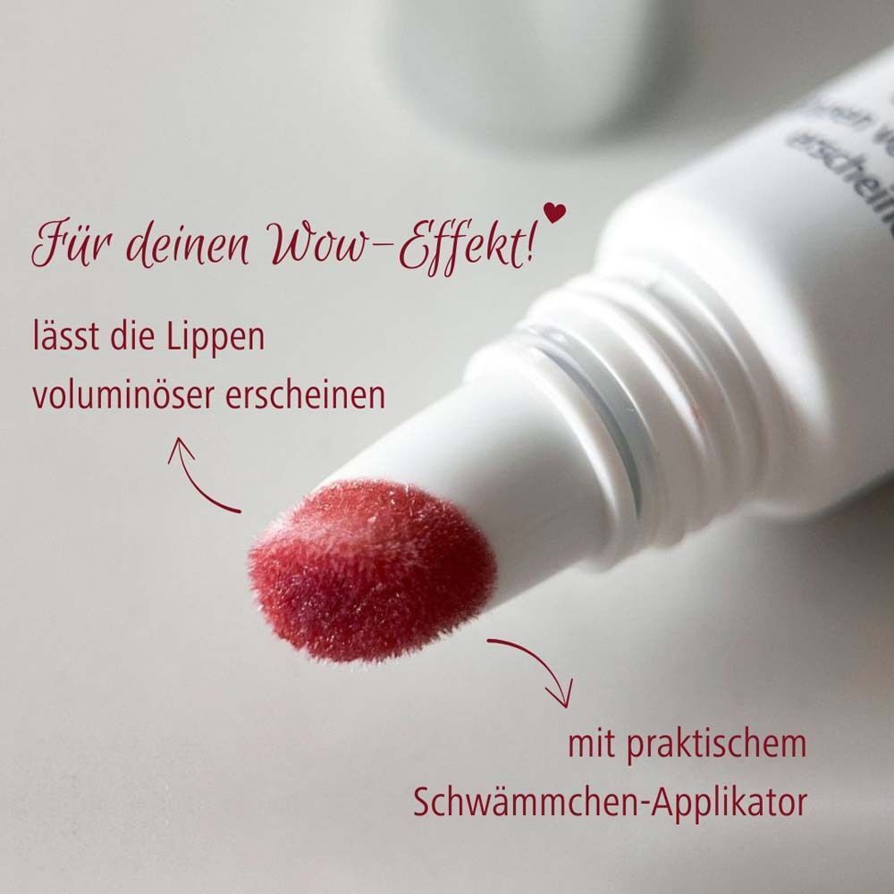 Nahaufnahme des Applikators. Weißer Tube mit rotem Lippenbalsam. Text: Mit praktischem Schwämmchen-Applikator. Lässt die Lippen voluminöser erscheinen.