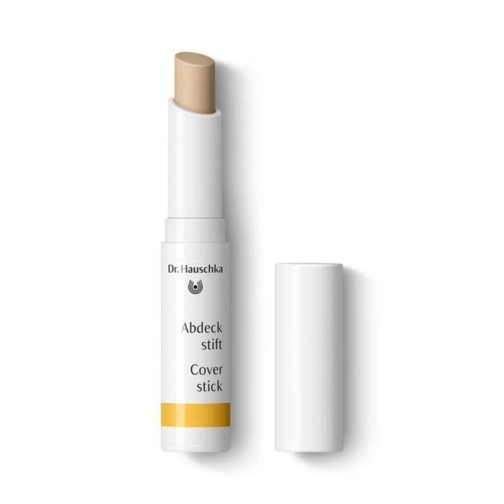 Weißer Coverstick mit geöffneter Kappe. Oben: Dr. Hauschka Logo. Text: Abdeckstift, Cover stick. Gelber Streifen am unteren Ende.