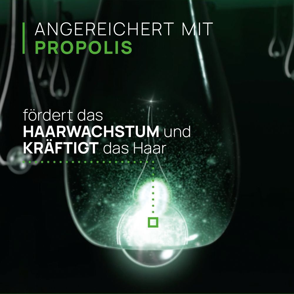 Ampulle in Tropfenform. Aufschrift: Fördert Haarwachstum und kräftigt das Haar.
