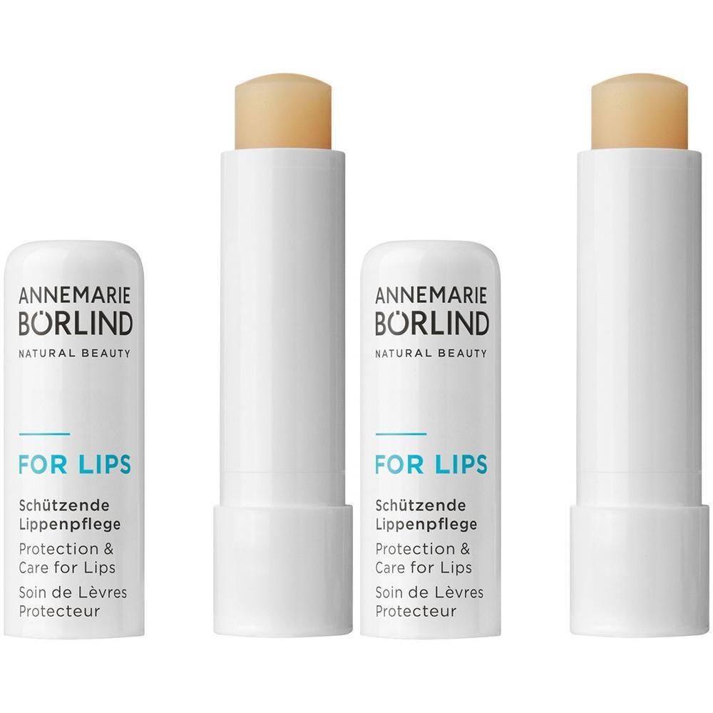 Zwei weiße Lippenpflege-Stifte von ANNEMARIE BÖRLIND, einer geöffnet, mit sichtbarem Produkt.
