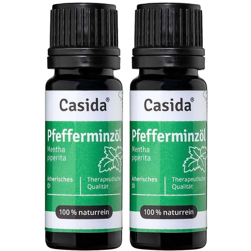 Zwei Flaschen Casida® Pfefferminzöl. Schwarze Kappen, grüne Etiketten mit weißer Schrift und einem Blatt-Symbol.