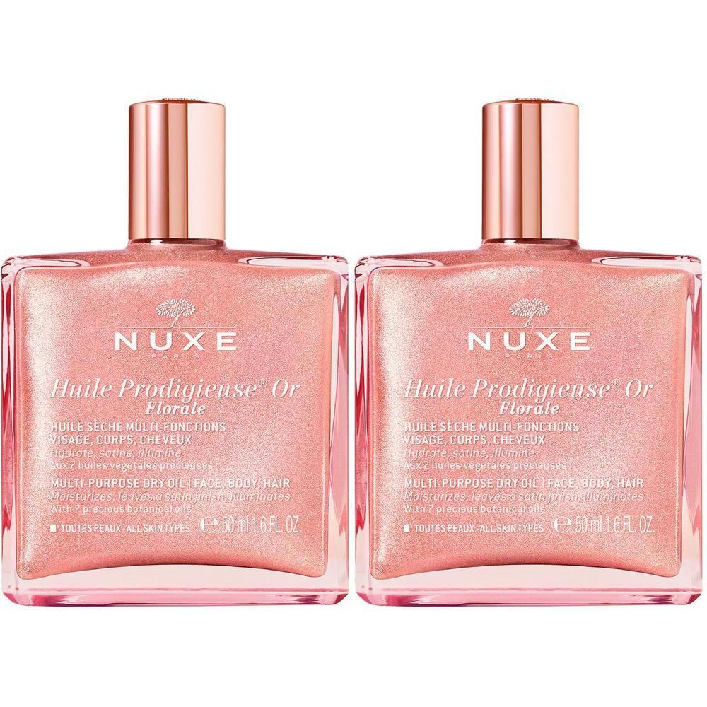 Zwei Flakons mit rosafarbenem Öl. Aufschrift: Nuxe Huile Prodigieuse® Or Florale. Quadratische Flakons mit goldenen Verschlüssen.