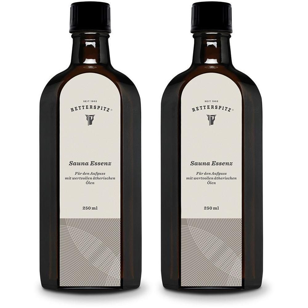 Zwei braune Flaschen mit schwarzem Verschluss. Auf dem Etikett steht "Sauna Essenz" und "250 ml".