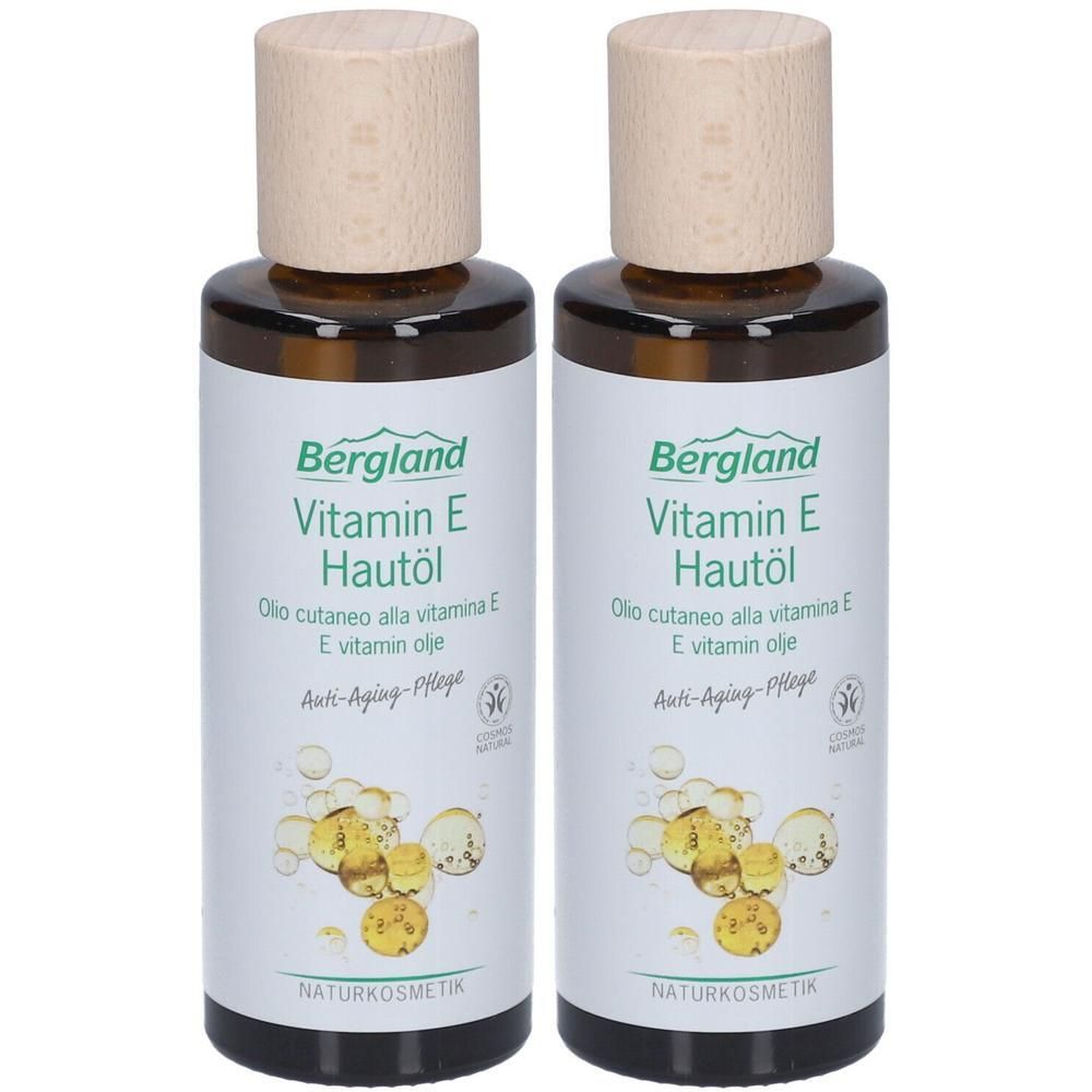 Zwei Flaschen Bergland Vitamin E Hautöl. Braune Glasflaschen mit Holzdeckel. Etikett mit Produktnamen, Inhaltsstoffen und Naturkosmetik-Logo.