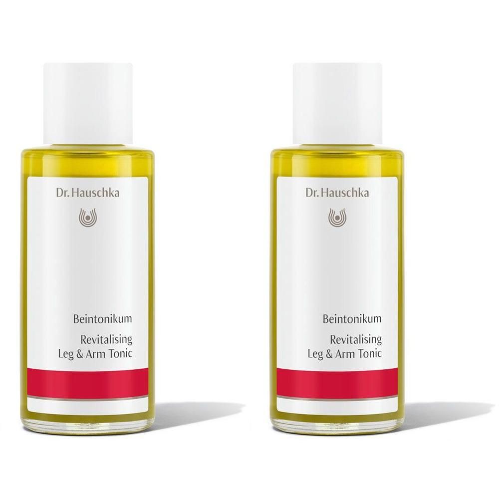 Zwei Flaschen Dr. Hauschka Beintonikum mit weißem Verschluss und rotem Band.